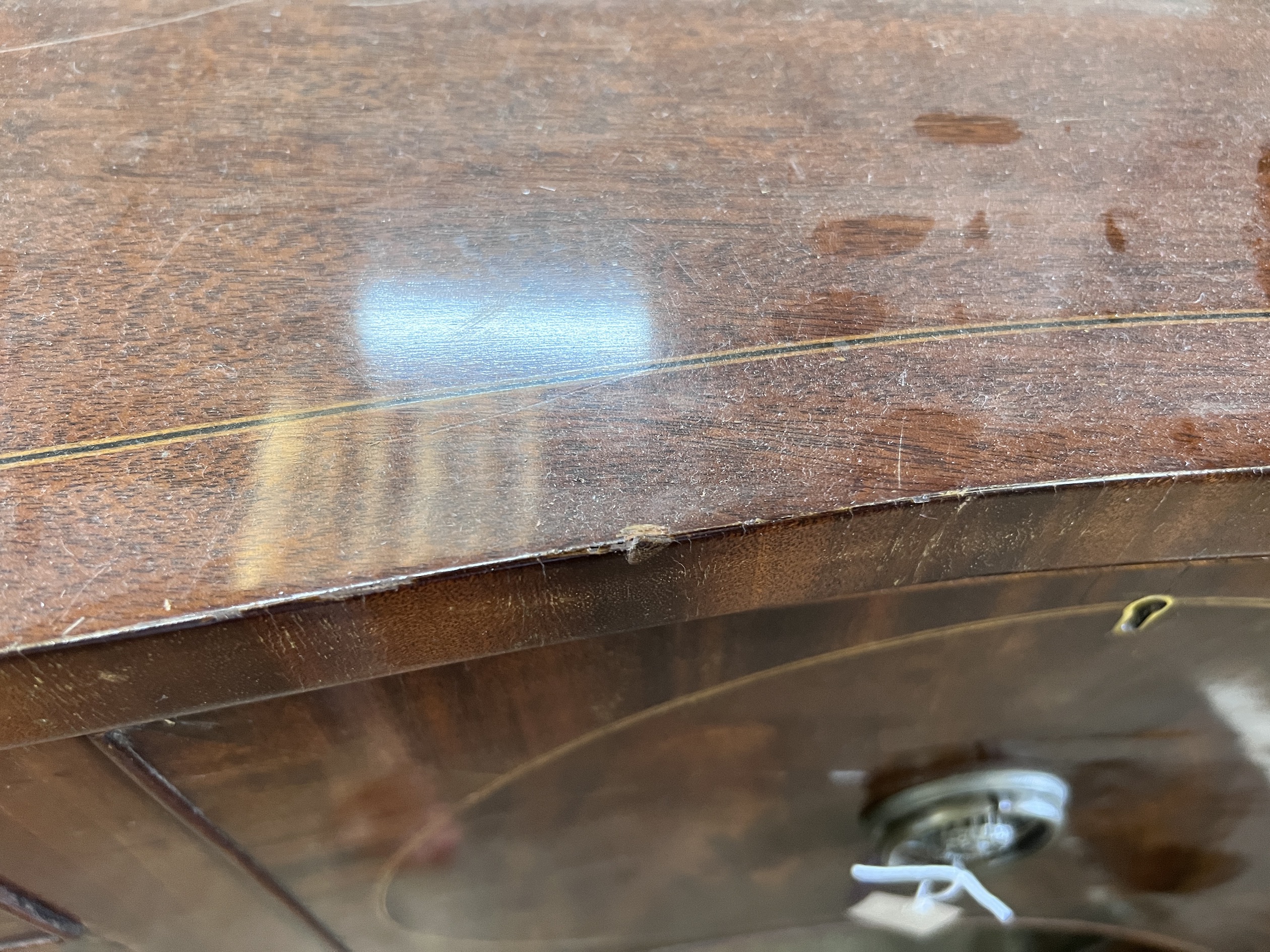 A George III style mahogany serpentine sideboard on square tapered legs, width 184cm, depth 63cm, height 93cm